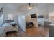 This modern, shared bedroom features a ceiling fan, hard wood floors and a mounted television at 3058 E Nance St, Mesa, AZ 85213
