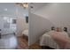 This bedroom features hardwood floors, a mounted tv, and is separated from another bedroom by a divider at 3058 E Nance St, Mesa, AZ 85213