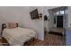 Bedroom with hardwood floors, a mounted TV, and entrance to the rest of the home at 3058 E Nance St, Mesa, AZ 85213