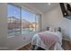 Bright bedroom features a large window overlooking a beautiful backyard pool at 3058 E Nance St, Mesa, AZ 85213