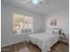 Bedroom features hardwood floors, a ceiling fan, and a large window at 3058 E Nance St, Mesa, AZ 85213