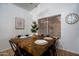 Bright dining room features a wooden table, setting for six, and natural lighting from a nearby window at 3058 E Nance St, Mesa, AZ 85213