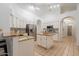 Well-lit kitchen with white cabinets, tile flooring, granite countertops and stainless steel appliances at 3058 E Nance St, Mesa, AZ 85213