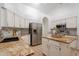 Modern kitchen featuring white cabinets, stainless steel appliances, granite countertops and tiled backsplash at 3058 E Nance St, Mesa, AZ 85213