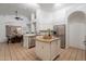 Bright kitchen with white cabinets, stainless steel appliances, and a central island, perfect for entertaining at 3058 E Nance St, Mesa, AZ 85213