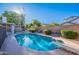 Backyard featuring a pool, surrounded by a patio, with mature landscaping at 3058 E Nance St, Mesa, AZ 85213