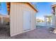 A backyard storage shed with a metal door, surrounded by a dirt landscape and the fence in the background at 3058 E Nance St, Mesa, AZ 85213