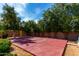 Backyard basketball court surrounded by mature trees and landscaping creating a nice backdrop at 320 N Portland Ave, Gilbert, AZ 85234