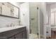 Contemporary bathroom with a marble-tiled shower and gray vanity at 320 N Portland Ave, Gilbert, AZ 85234