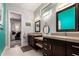 Bathroom featuring dual vanities, plentiful mirrors, and an office space through the doorway at 320 N Portland Ave, Gilbert, AZ 85234