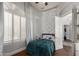 Cozy bedroom with window shutters, overhead light, and door to ensuite bathroom at 320 N Portland Ave, Gilbert, AZ 85234