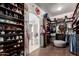 Spacious closet with shoe shelves, hanging clothes, and an arched entrance to the bathroom at 320 N Portland Ave, Gilbert, AZ 85234