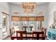 Bright dining room with natural light, a stylish chandelier, and views of the outdoor area at 320 N Portland Ave, Gilbert, AZ 85234