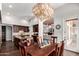 Elegant dining room showcasing an island that connects to the kitchen and a stylish chandelier at 320 N Portland Ave, Gilbert, AZ 85234