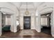 Bright and open foyer featuring high ceilings, a modern chandelier, and elegant archways at 320 N Portland Ave, Gilbert, AZ 85234