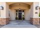 Covered front porch with stone accents, stylish lighting, and a decorative iron gate at 320 N Portland Ave, Gilbert, AZ 85234