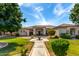 Beautiful single-story home featuring lush landscaping, a paved walkway, and a welcoming entrance at 320 N Portland Ave, Gilbert, AZ 85234
