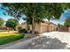 Charming home showcasing a mature tree, well-manicured lawn, and a spacious three-car garage at 320 N Portland Ave, Gilbert, AZ 85234