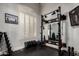 Well-equipped home gym with weights, power rack, and a mirrored wall at 320 N Portland Ave, Gilbert, AZ 85234