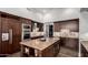 Gourmet kitchen with stainless steel appliances, a large island, and custom cabinetry at 320 N Portland Ave, Gilbert, AZ 85234