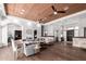 Expansive living area with wood floors, a coffered ceiling, and seamless flow to other rooms at 320 N Portland Ave, Gilbert, AZ 85234