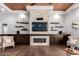 Cozy sitting area with a stone fireplace, built-in shelving, and hardwood floors at 320 N Portland Ave, Gilbert, AZ 85234