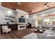 Spacious living room featuring a modern stone fireplace, wood-paneled ceiling, and ample natural light at 320 N Portland Ave, Gilbert, AZ 85234