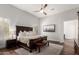 Serene bedroom with a large bed, ceiling fan, and neutral decor at 320 N Portland Ave, Gilbert, AZ 85234