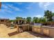An outdoor kitchen and grilling area is next to a covered seating area and a basketball court at 320 N Portland Ave, Gilbert, AZ 85234