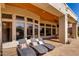 Inviting outdoor patio with lounge chairs and expansive glass windows at 320 N Portland Ave, Gilbert, AZ 85234