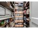Walk-in pantry offering ample storage space with shelving and drawers at 320 N Portland Ave, Gilbert, AZ 85234