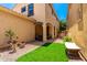 Private backyard with manicured turf, covered patio and stylish gravel landscaping at 3476 E Orchid Ln, Gilbert, AZ 85296
