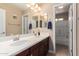 Bathroom features dual vanity sinks, medicine cabinets and a separate toilet room and shower at 3476 E Orchid Ln, Gilbert, AZ 85296