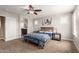 Primary bedroom with archway to bathroom, ceiling fan, and stylish decor at 3476 E Orchid Ln, Gilbert, AZ 85296