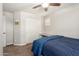 Bedroom features neutral walls, carpet floors, and blue quilt bedding at 3476 E Orchid Ln, Gilbert, AZ 85296