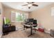 Office bedroom with a ceiling fan, neutral tones, large window, and carpet floors at 3476 E Orchid Ln, Gilbert, AZ 85296