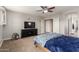 Comfortable bedroom with plush carpet, ceiling fan, and ample closet space at 3476 E Orchid Ln, Gilbert, AZ 85296