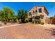 Charming two-story home with a desert landscape and walkway to the front door at 3476 E Orchid Ln, Gilbert, AZ 85296
