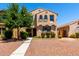 Charming two-story home with a desert landscape and walkway to the front door at 3476 E Orchid Ln, Gilbert, AZ 85296