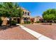 Charming two-story home with a desert landscape and walkway to the front door at 3476 E Orchid Ln, Gilbert, AZ 85296