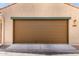 A brown garage door with decorative trim and house number for added curb appeal at 3476 E Orchid Ln, Gilbert, AZ 85296