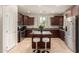 Gourmet kitchen featuring dark wood cabinetry, stainless appliances, and a center island at 3476 E Orchid Ln, Gilbert, AZ 85296