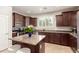 Stylish kitchen with granite counters, stainless appliances, and modern island seating at 3476 E Orchid Ln, Gilbert, AZ 85296