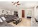 Spacious living room boasts tile floors, a sectional sofa, and easy access to the kitchen at 3476 E Orchid Ln, Gilbert, AZ 85296