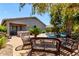 The backyard is complete with a hot tub, patio seating, and a refreshing pool surrounded by tropical trees at 35654 N Vidlak Dr, San Tan Valley, AZ 85143