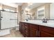 Bathroom featuring double sinks, modern cabinets, and glass shower doors for a sleek design at 35654 N Vidlak Dr, San Tan Valley, AZ 85143