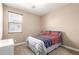 Bedroom with neutral walls, carpet flooring, and a large window offering plenty of natural light at 35654 N Vidlak Dr, San Tan Valley, AZ 85143