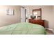 View of the bedroom, showcasing a dresser with mirror and an open doorway to other rooms at 35654 N Vidlak Dr, San Tan Valley, AZ 85143