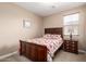 Bedroom with carpet, side table, a dark wood bed, and a window with natural light at 35654 N Vidlak Dr, San Tan Valley, AZ 85143