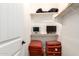 Small closet features dual monitors, storage cushions, and shelving for organized space at 35654 N Vidlak Dr, San Tan Valley, AZ 85143